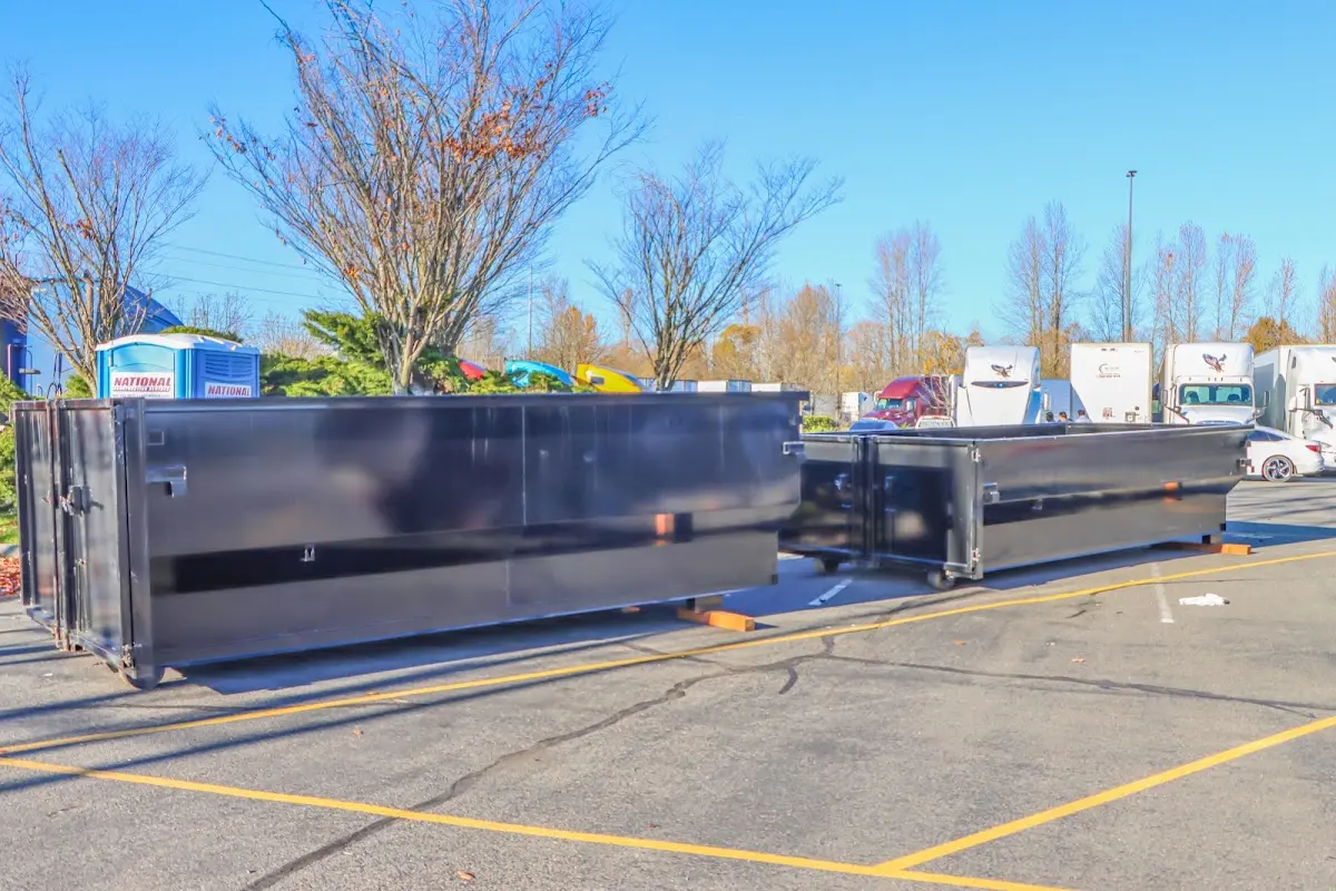 Professional dumpster rental service with roll-off container on residential driveway in Nephi